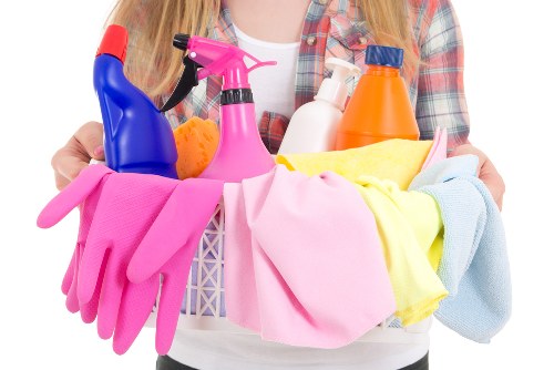 Cleaning worker applying safe practices in a professional environment